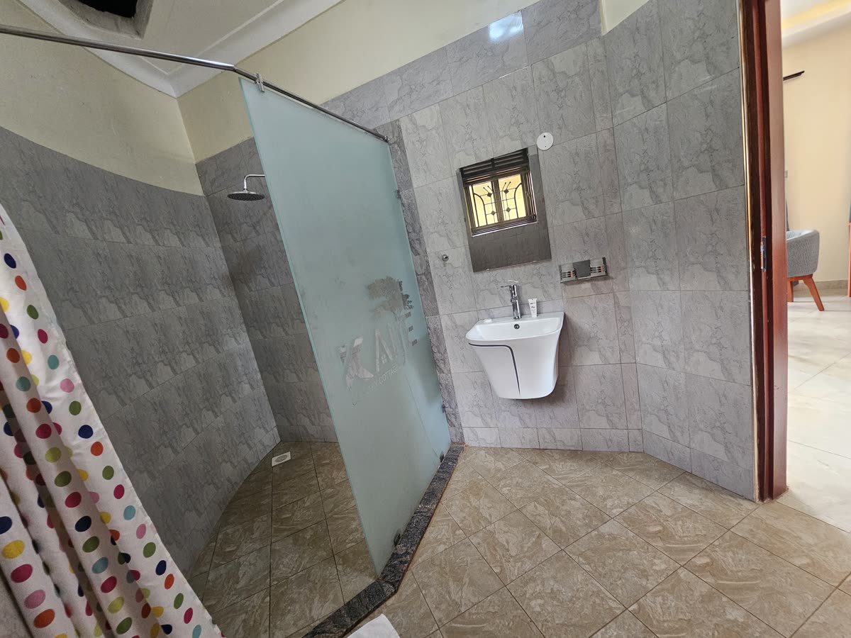 En-suite bathroom with a glass shower and basin