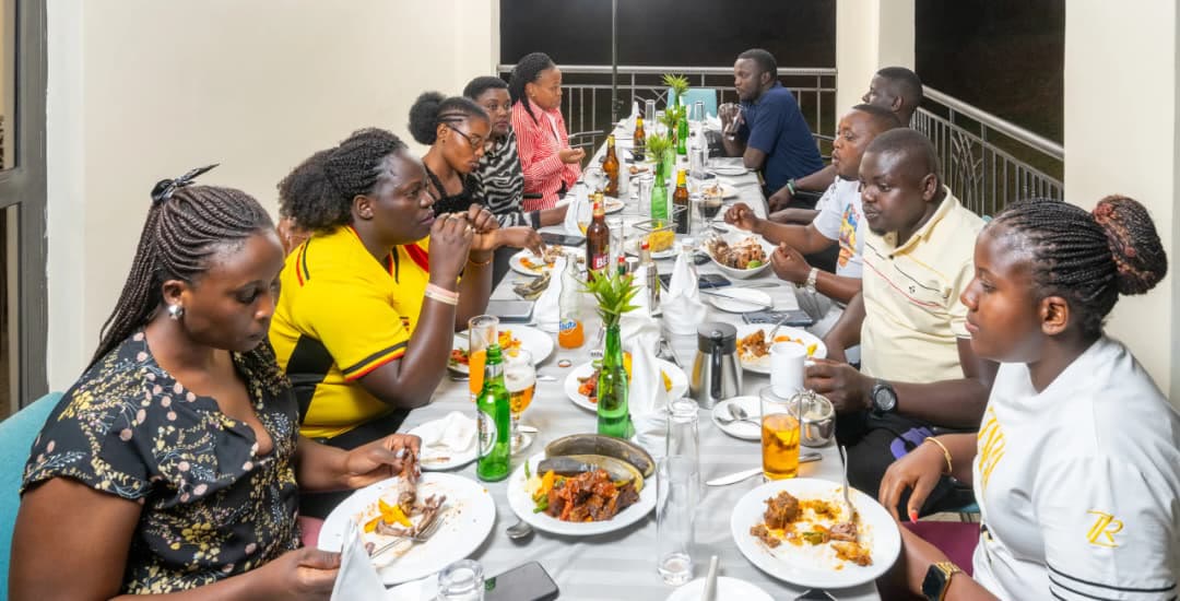 A long table of guests sharing a meal