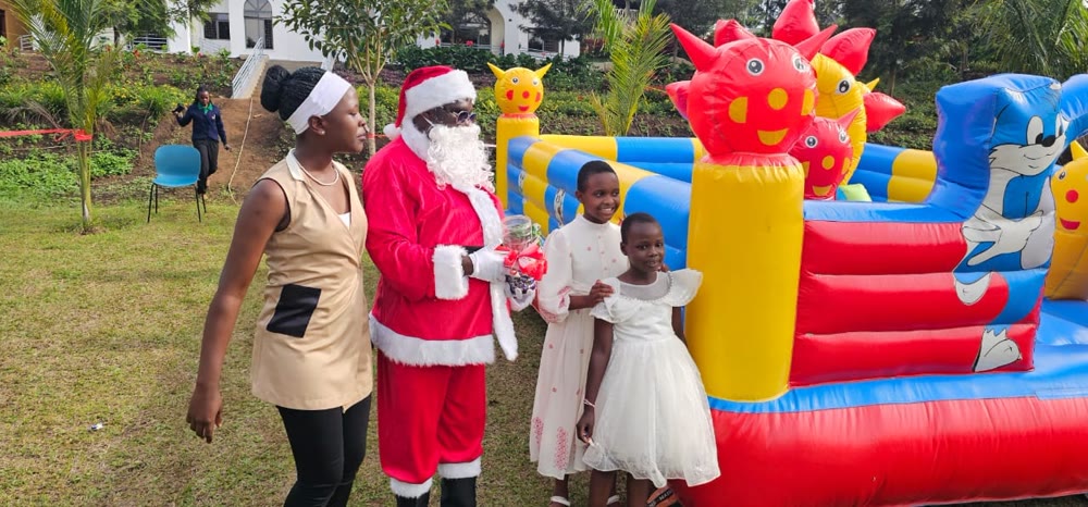Children meeting Santa beside a bouncy castle on the lawn