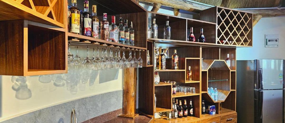The back bar with bottles, glasses and a wine rack