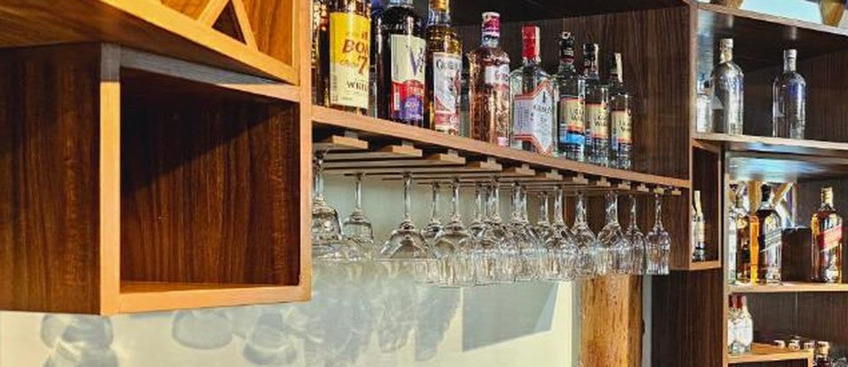 Whisky and spirits on the wooden shelves of Turaco Bar