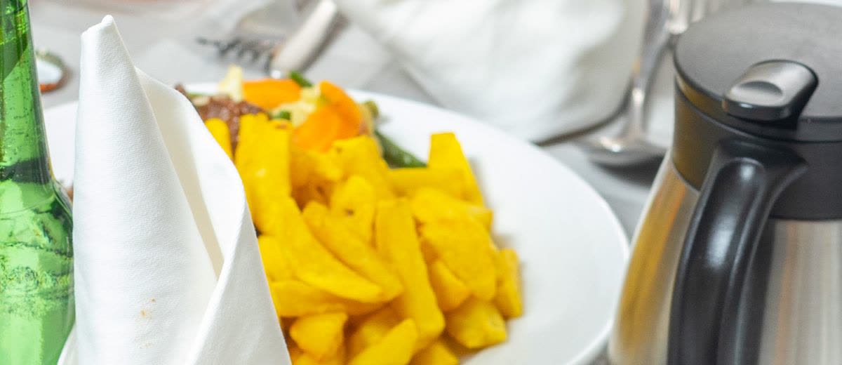 A plate of chips on a white tablecloth