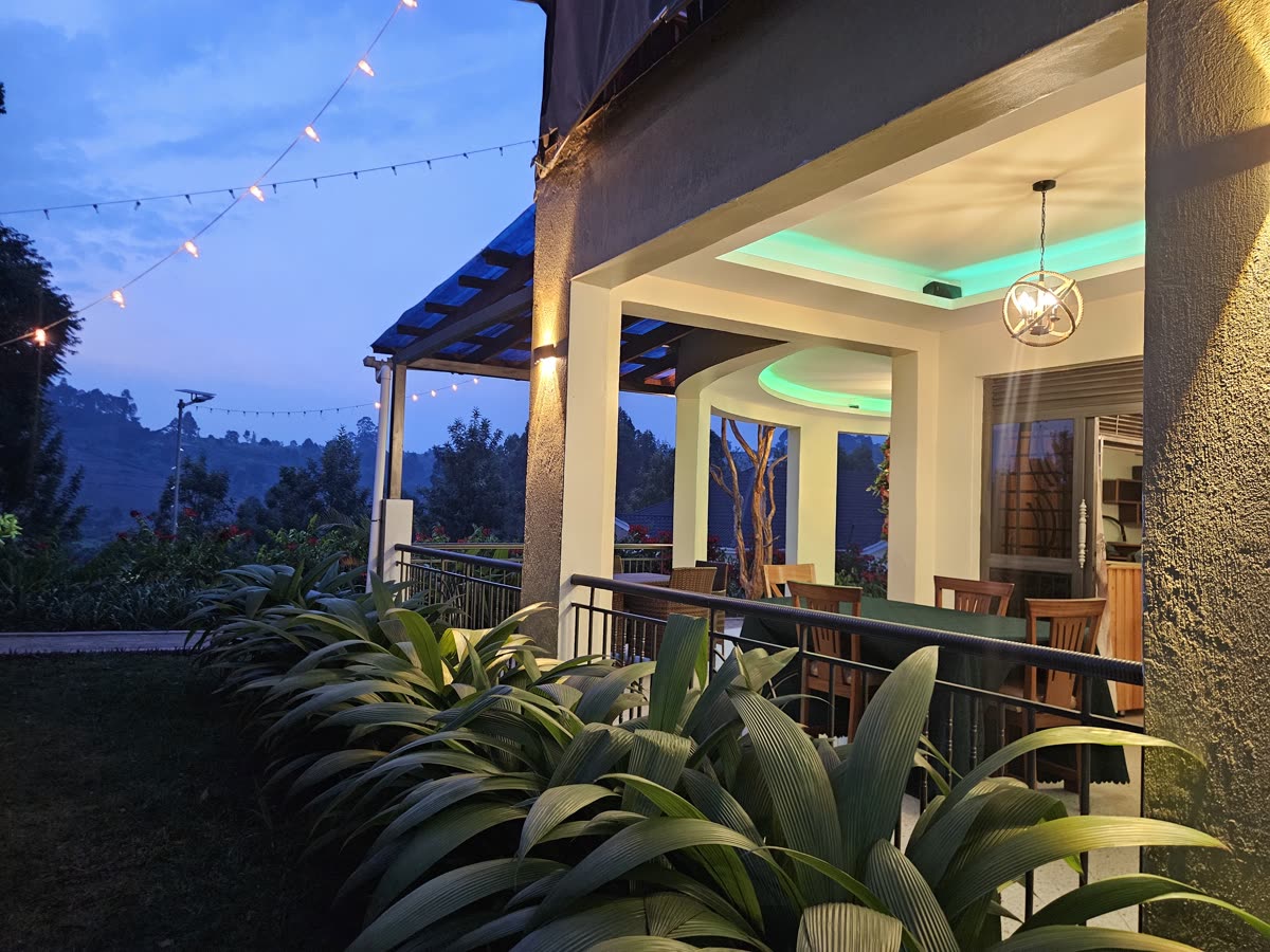 The restaurant terrace at dusk, lit in green and gold
