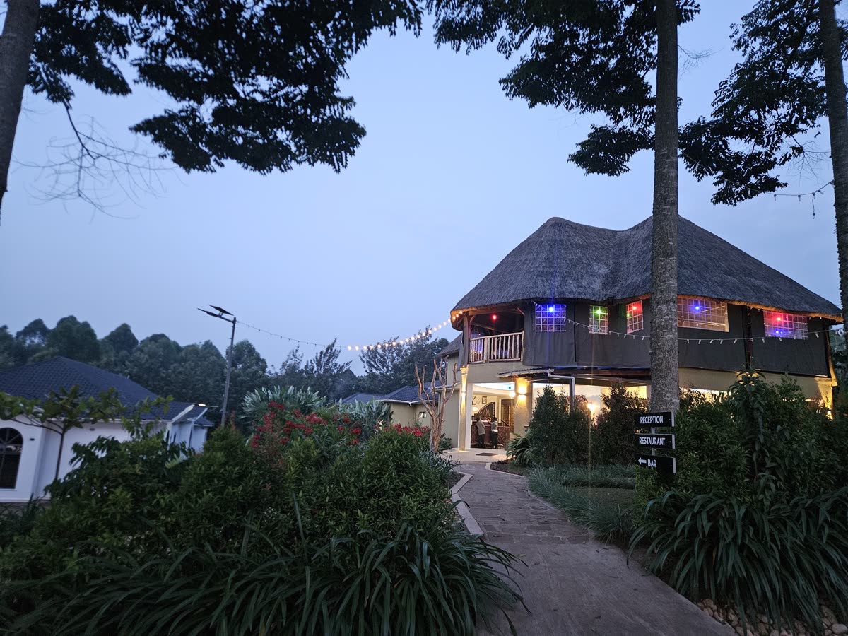 The thatched restaurant and bar glowing with lights at dusk