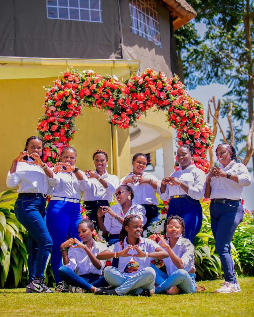 A celebration with a tiered cake under the flower arch