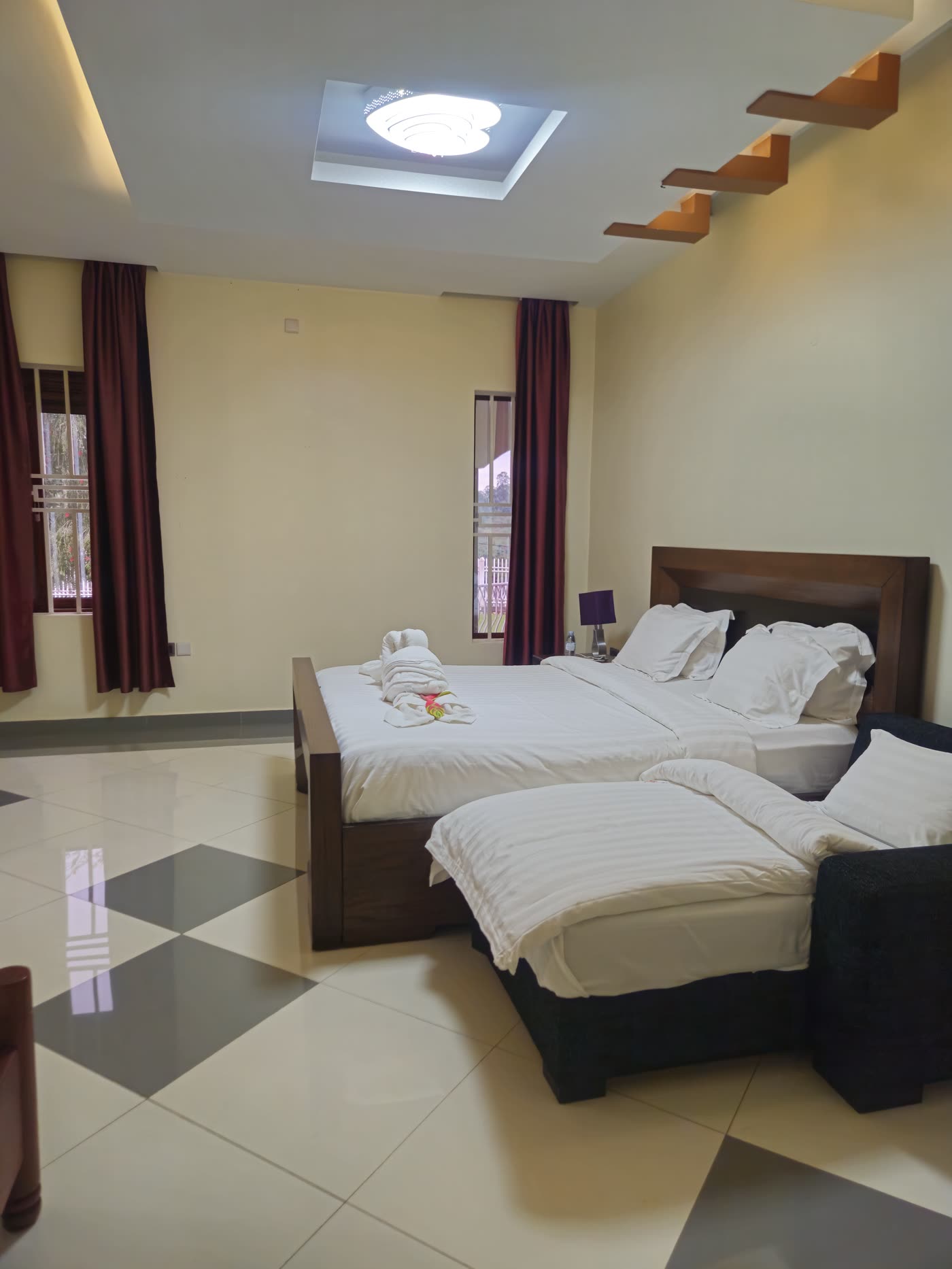 A double bed and a lounger in a bright villa room