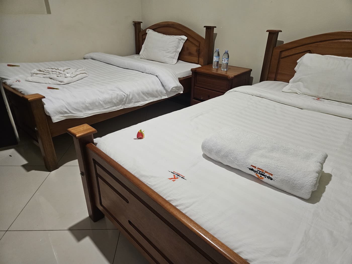 Two single beds made up with white linen