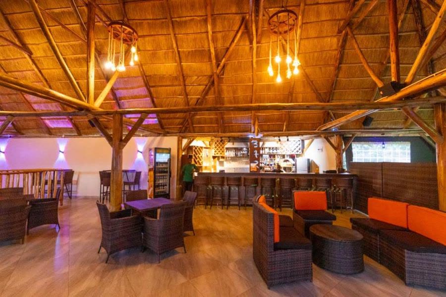 Turaco Bar under a high thatched roof with lounge seating